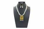 The Pearl necklace with gold pendant and matching earrings.