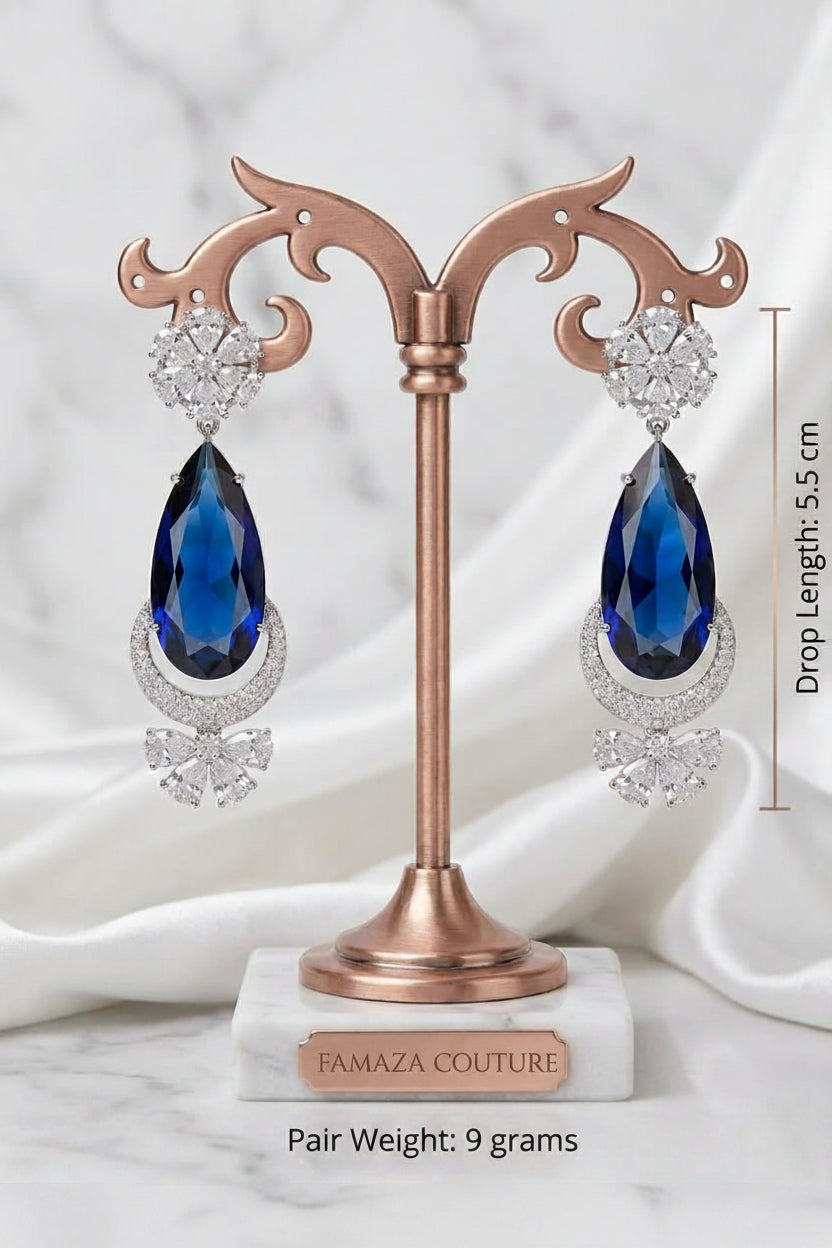Traditional 5 cm wide American Diamond Chaand Bali earrings with radiant ruby-red accents on a clean background.