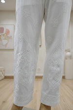The White stretchable cotton hand embroidered chikankari pants with pockets.