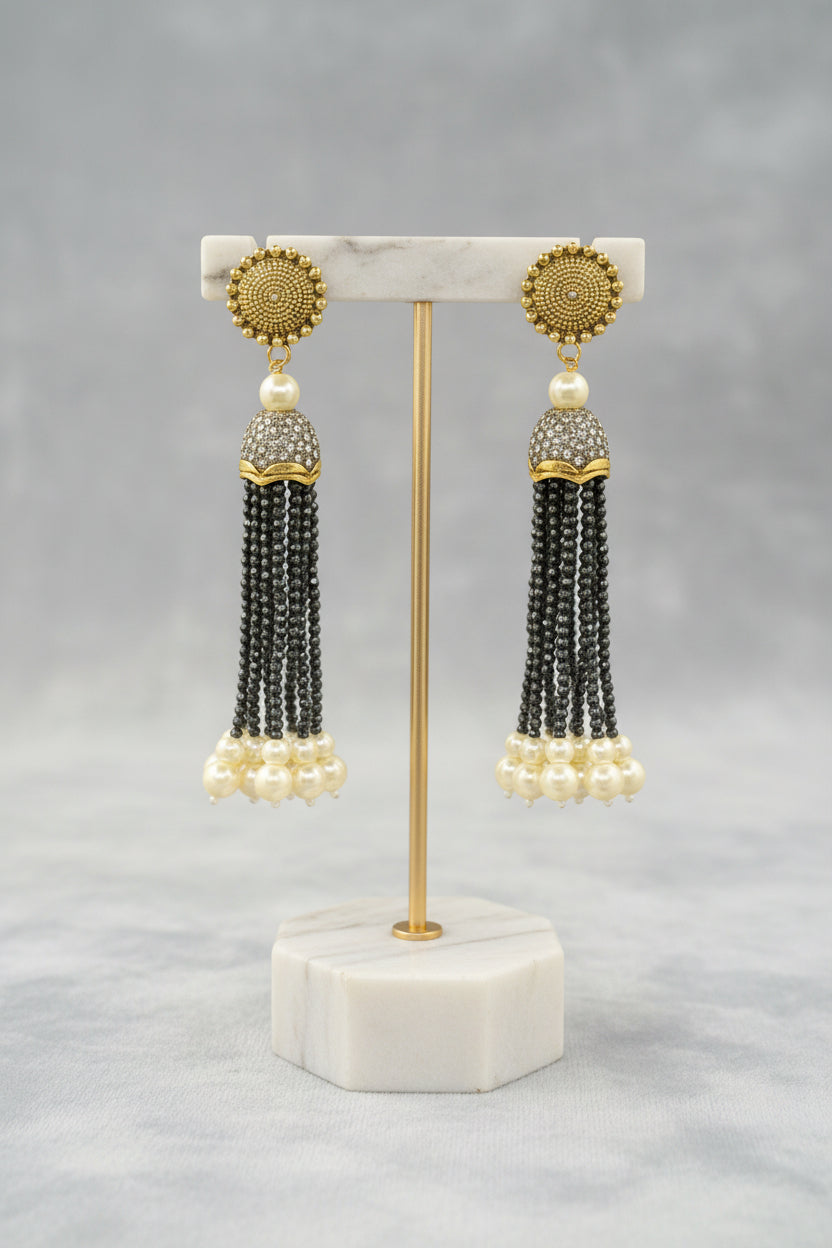The gold-plated Kundan-studded and pearl-beaded handcrafted earrings, displayed against a black background. Party wear earrings set.