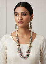 The luxurious Tanjore Art Meenakari multi-coloured beaded Mala Set featuring a bridal pearl necklace with accompanying earrings, predominantly in gold and white colours with ornate designs.