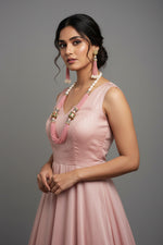 The luxurious Tanjore Art Meenakari pink beaded Mala Set featuring a bridal pearl necklace with accompanying earrings, predominantly in gold and white colours with ornate designs.