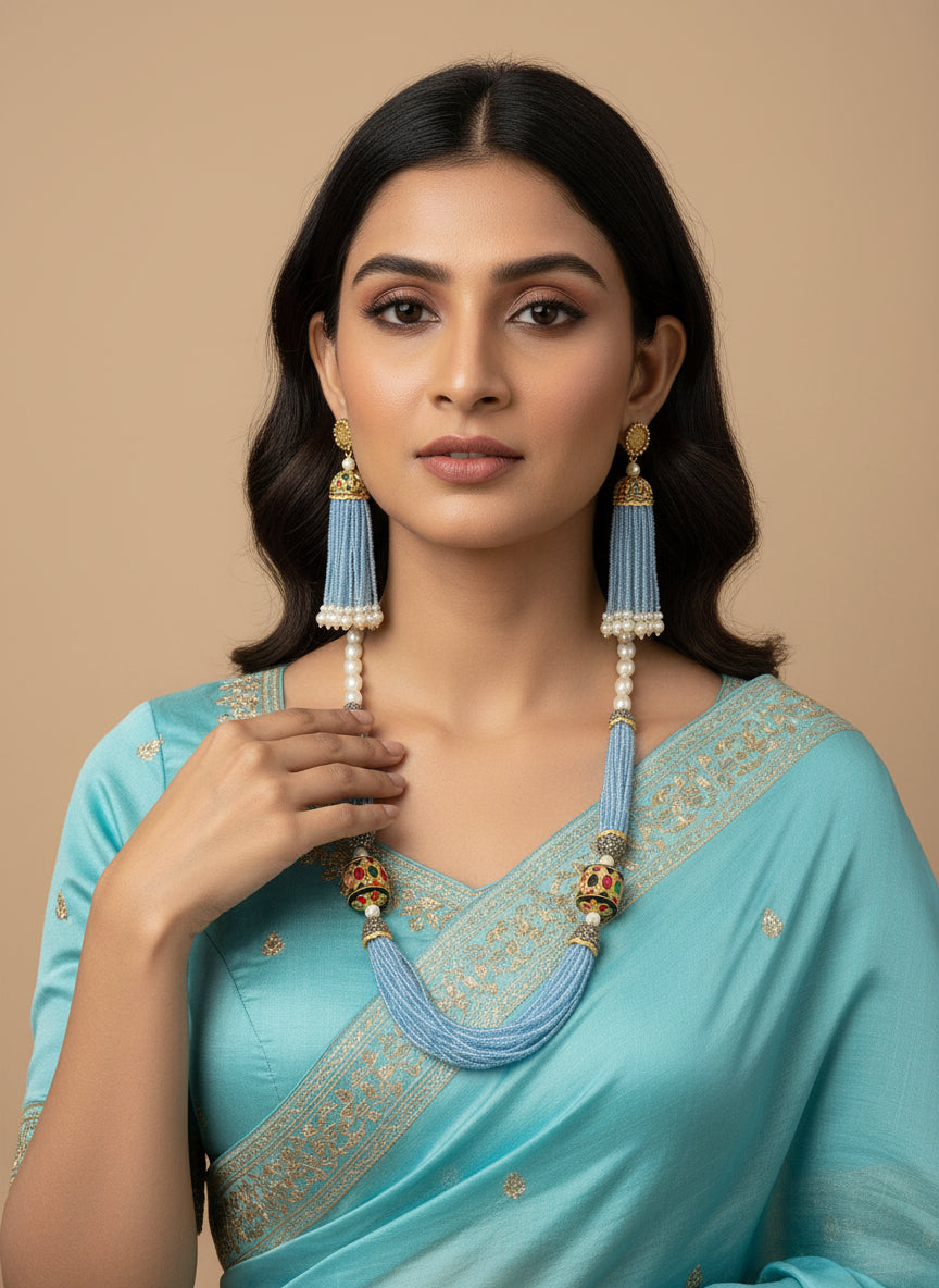 The luxurious Tanjore Art Meenakari sky blue beaded Mala Set featuring a bridal pearl necklace with accompanying earrings, predominantly in gold and white colours with ornate designs.
