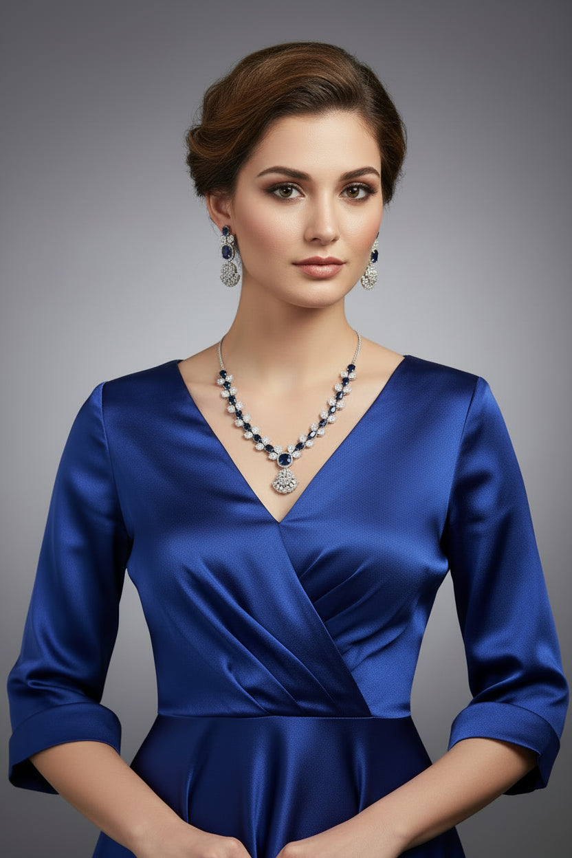 The mannequin showcasing a necklace set with green and white stones, accompanied by earrings and a maang tikka. Party wear set.