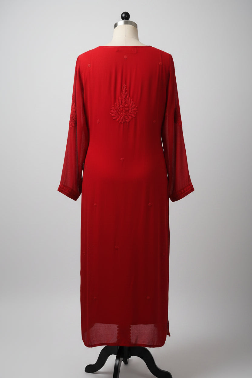 The rear view of a red long-sleeve kurta dress with a small embroidered floral motif on the chest, hanging on a white hanger against a black background.