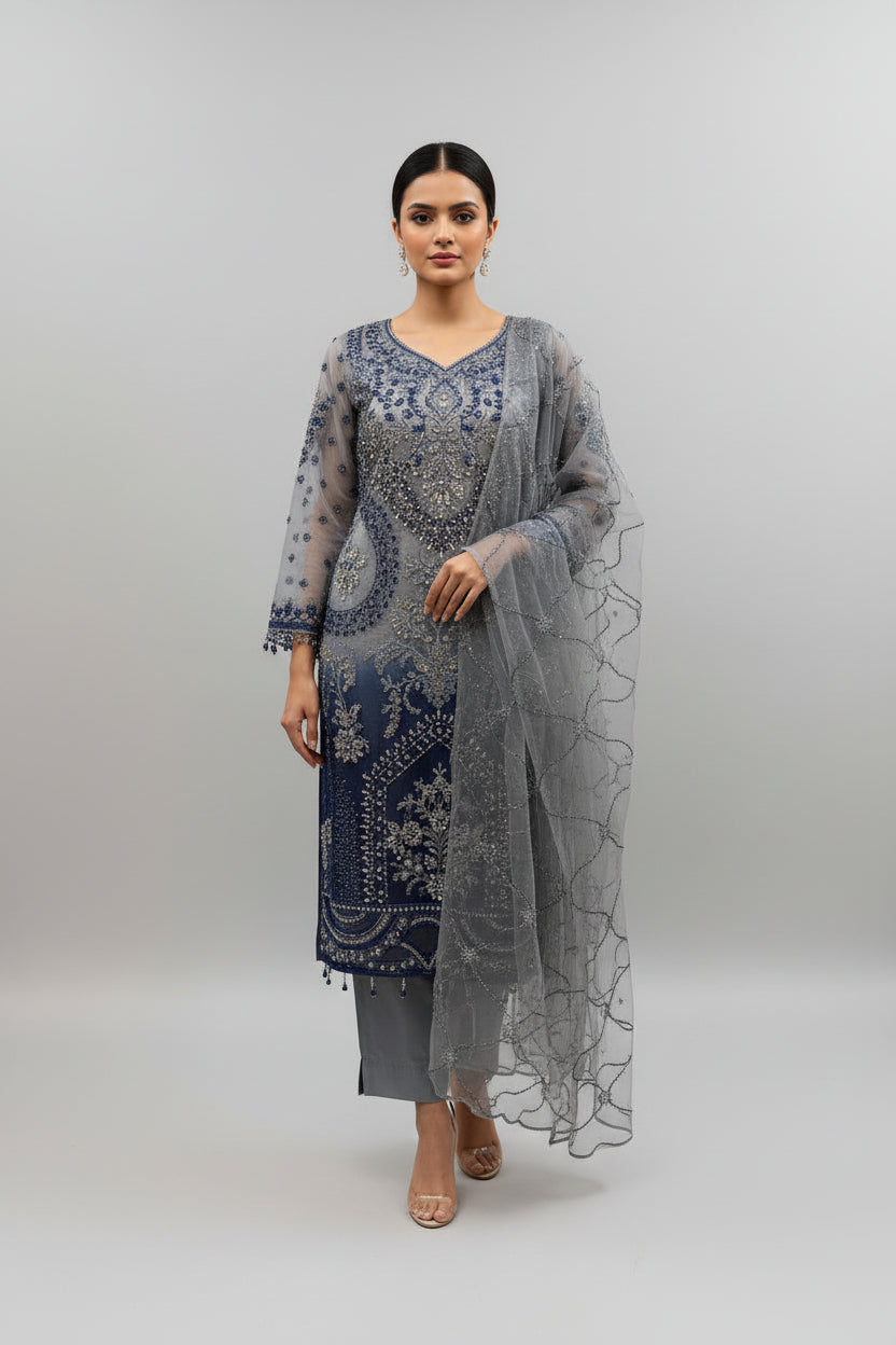 The side view and showing sleeves work of Net fabric in grey and navy blue two tone 3pcs Pakistani dress with hand embellishments on all over kurti and dupatta with plain grey silk straight trousers .