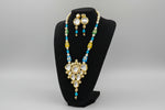 The traditional bridal necklace set displayed on a mannequin, featuring sky blue and gold colours with intricate detailing and pearl beads. Party wear jewellery set.