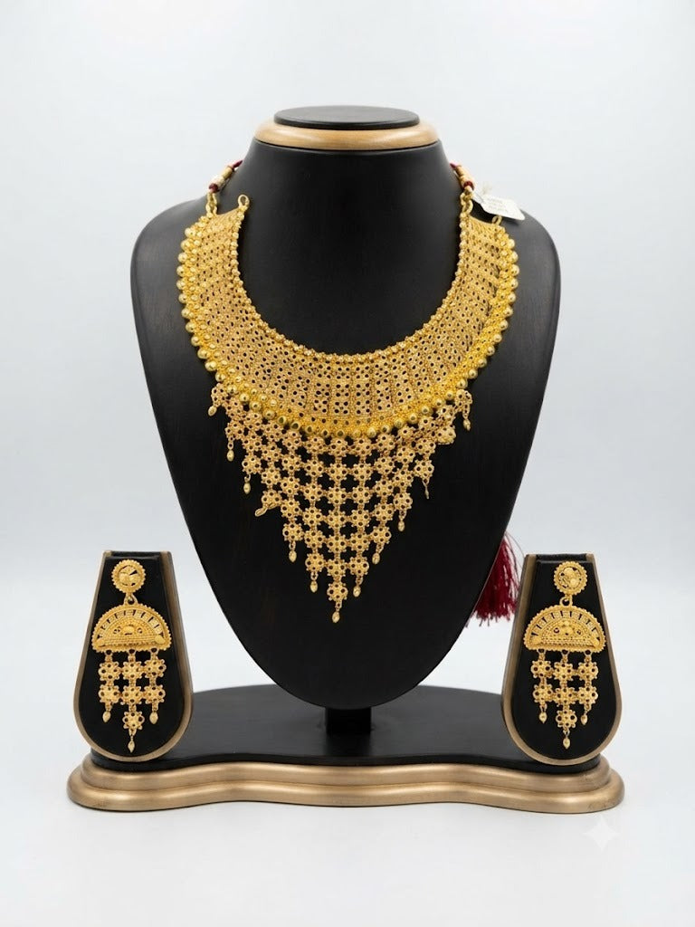 Wareesha Grand Filigree Gold-Plated Jewelry Ensemble by Famaza Couture displayed elegantly on a posh stand.