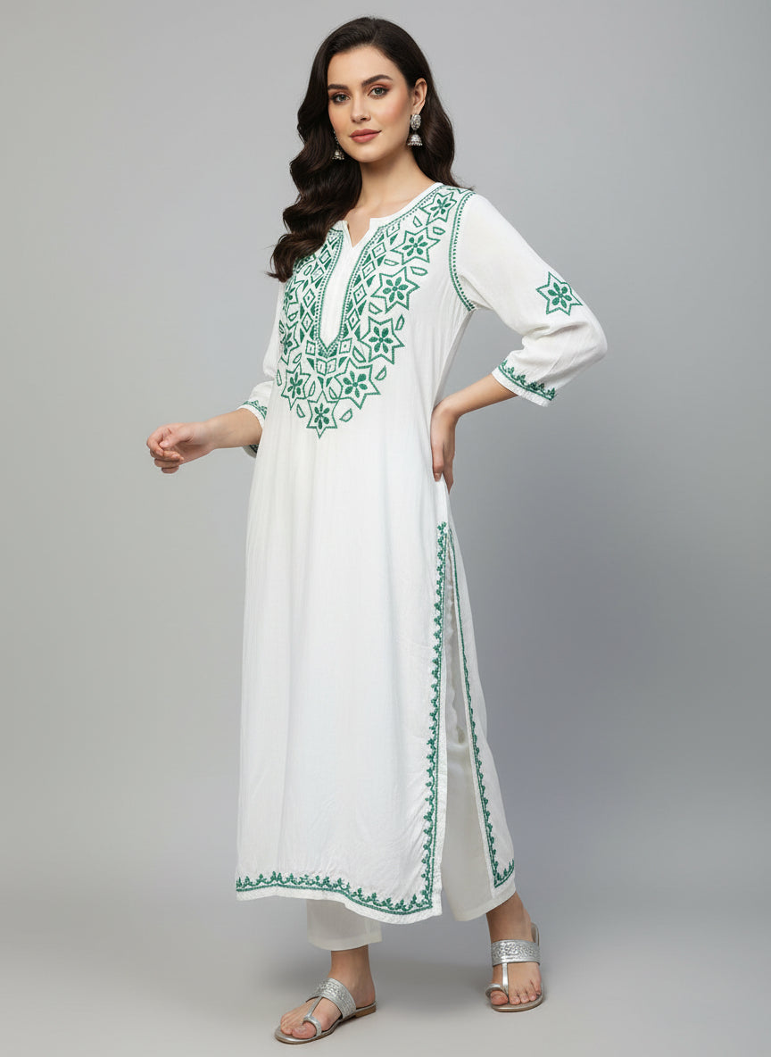 white based muslin fabric long kurti with hand embroidery with green colour thread on it's neck sleeves and slits and daaman