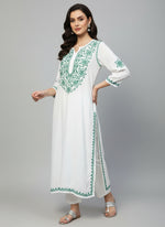 white based muslin fabric long kurti with hand embroidery with green colour thread on it's neck sleeves and slits and daaman
