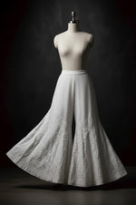 Classic white cotton flared sharara featuring delicate embroidery, traditional Indian/Pakistani style