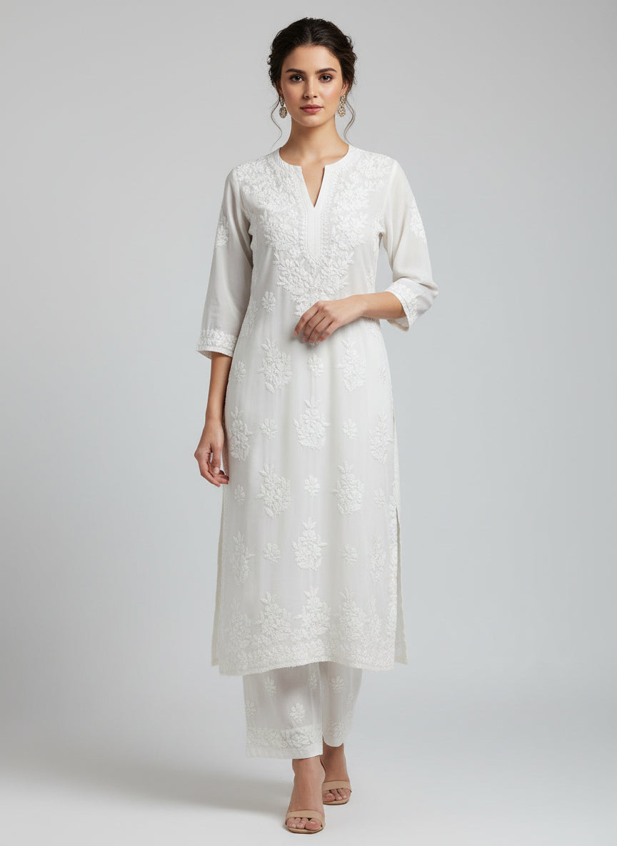 White colour modal fabric tone to tone hand embroidered kurti and trousers. Kurti is 46 inches long