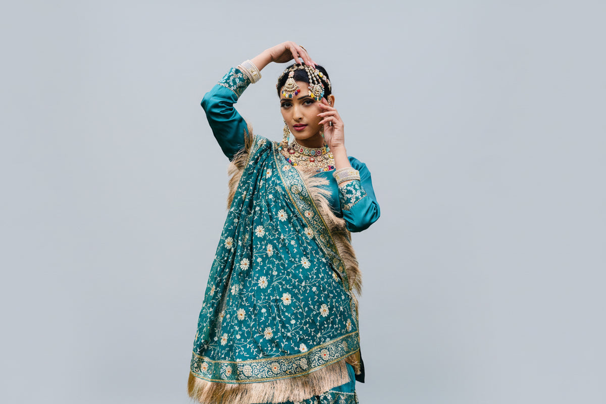 Woman in traditional attire with floral patterns outdoors