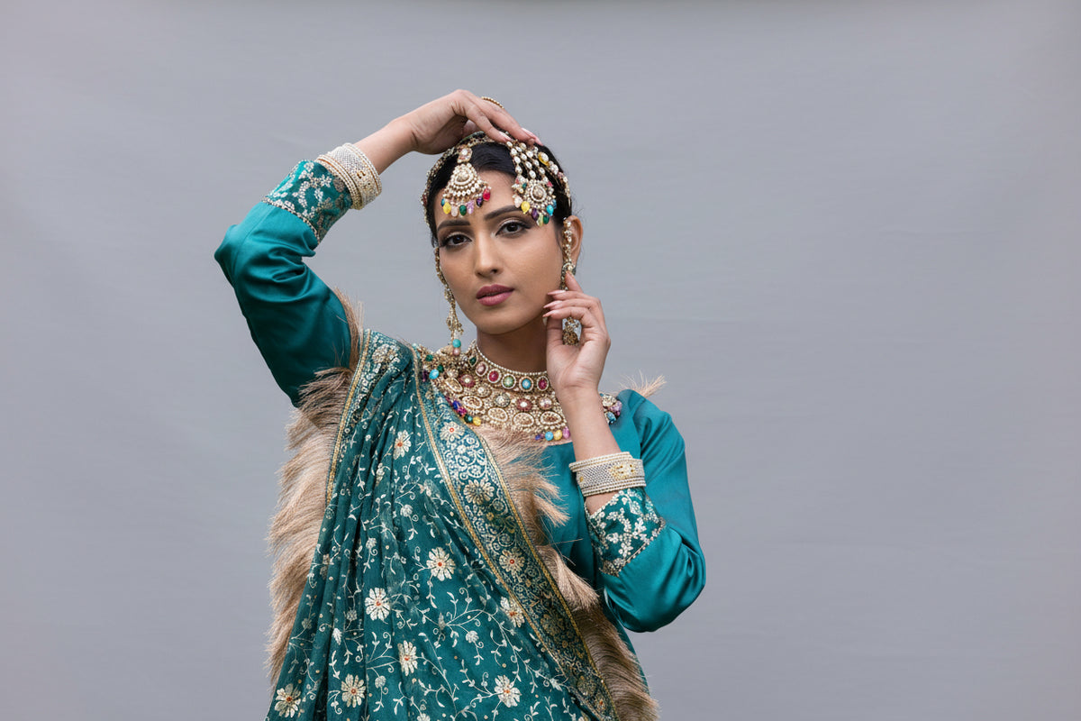Woman in traditional attire with jewelry outdoors