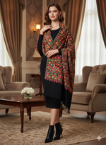 Woman wearing a floral shawl in an elegant room with curtains and furniture.