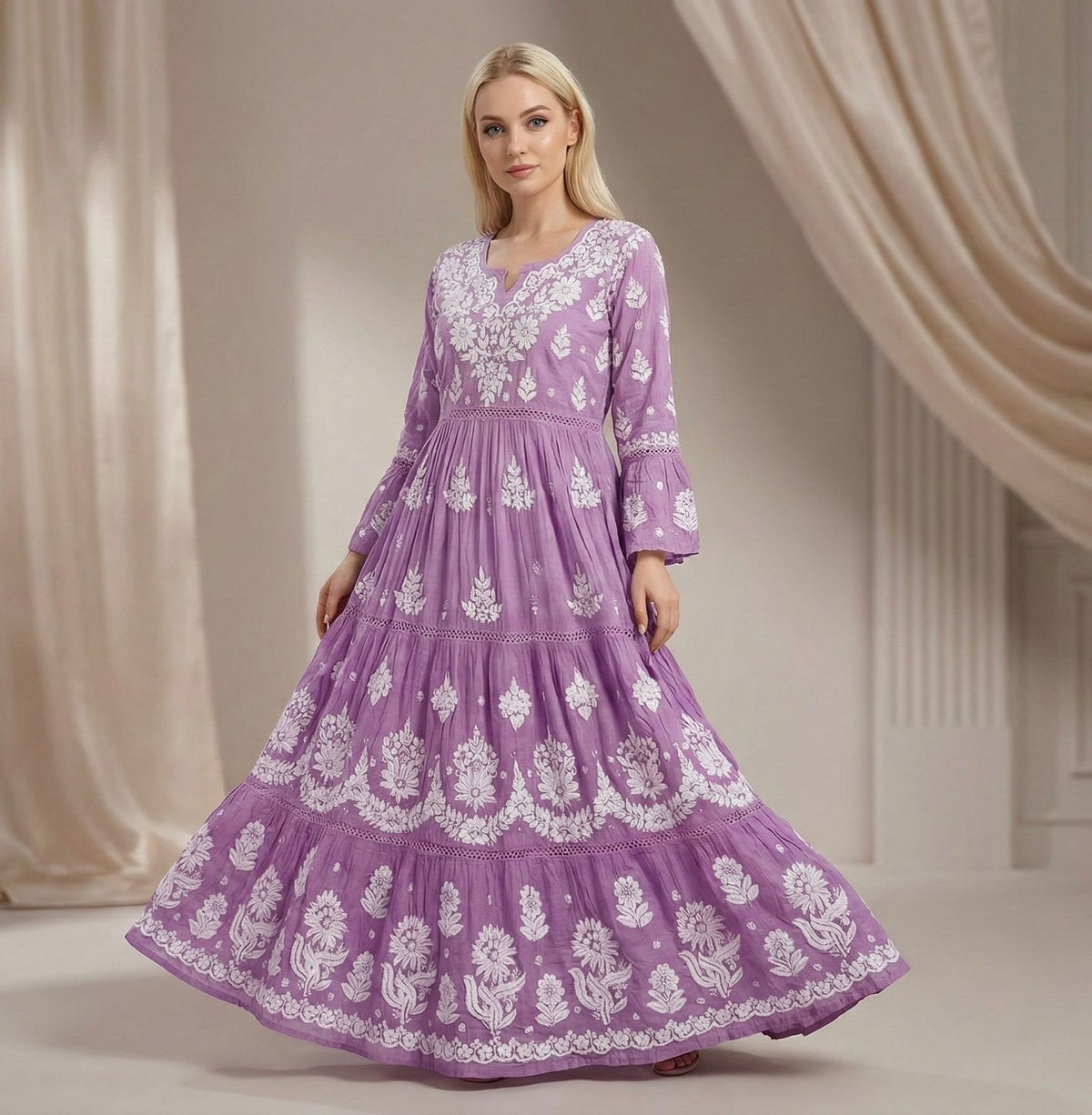 Woman wearing a purple dress with white embroidery in a studio setting