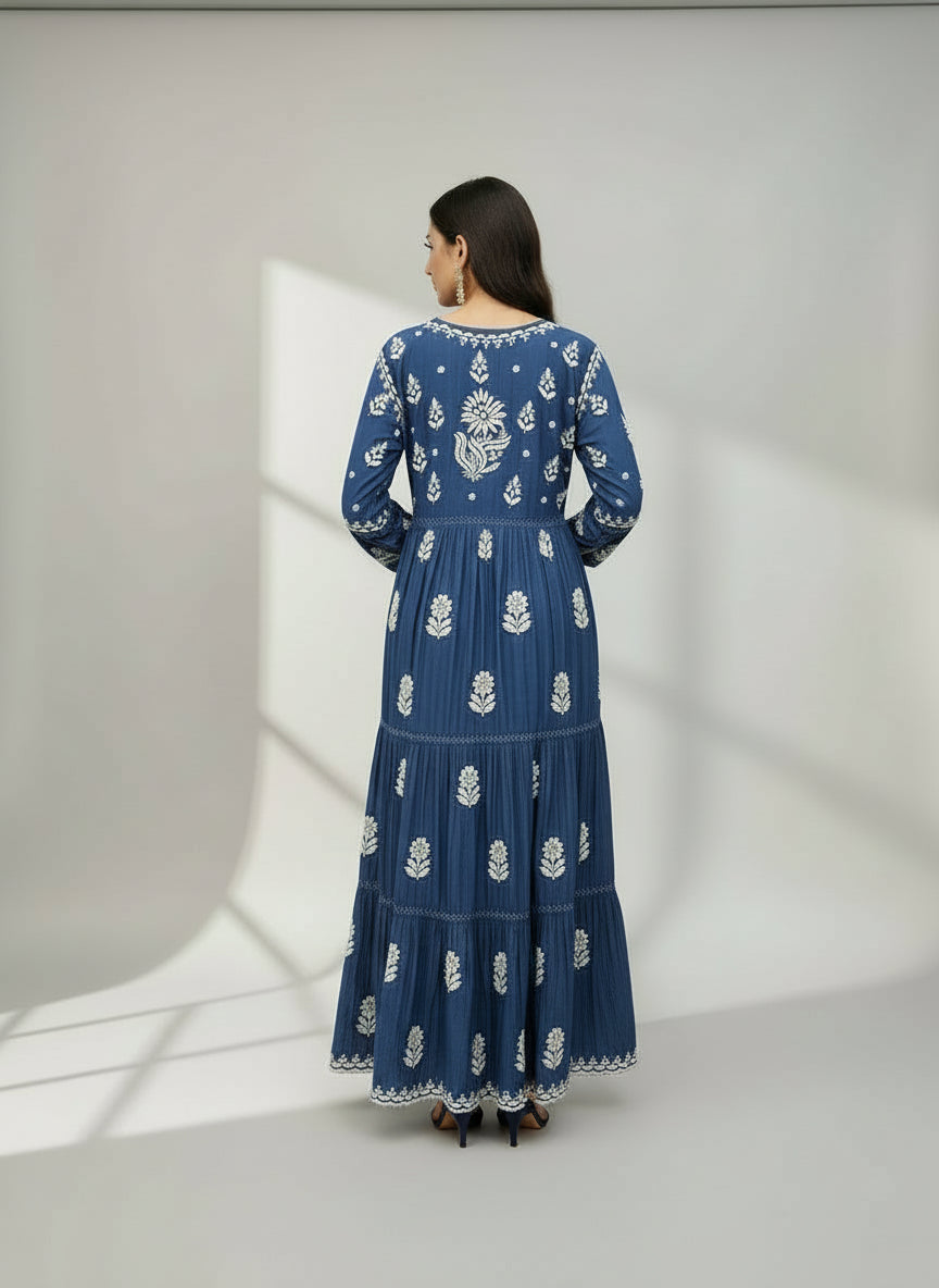 Woman wearing and showing rear view design of this navy blue colour dress with white floral patterns in a neutral setting.