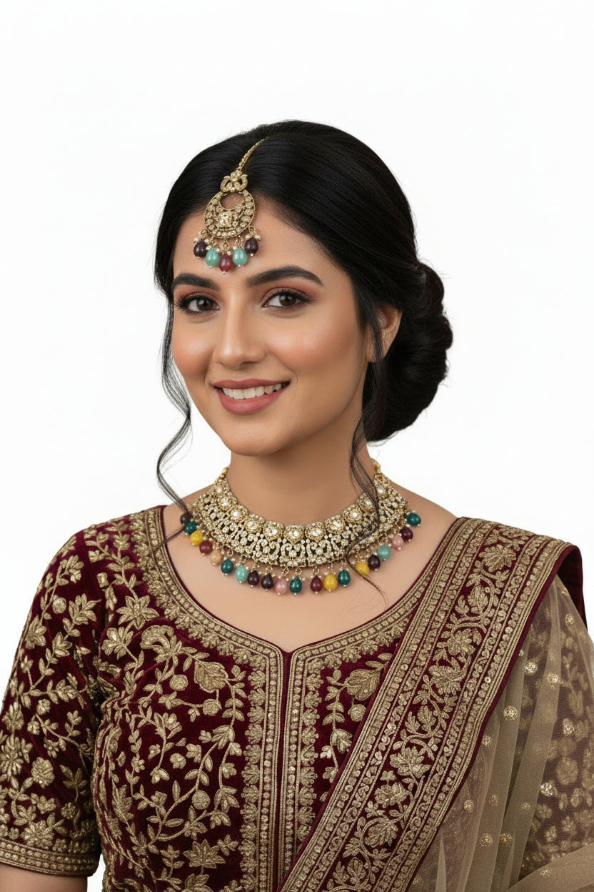 Woman wearing traditional jewelry and attire against a draped curtain background
