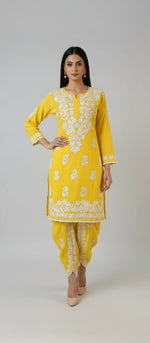 Yellow colour cotton fabric kurti and dhoti trousers back side design is showing in this image.
