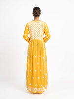 Yellow dress with white embroidery on a white background