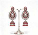 a pair of oxidised tone tear drop earrings with red nano stones and hangings are displayed on a silver stand.