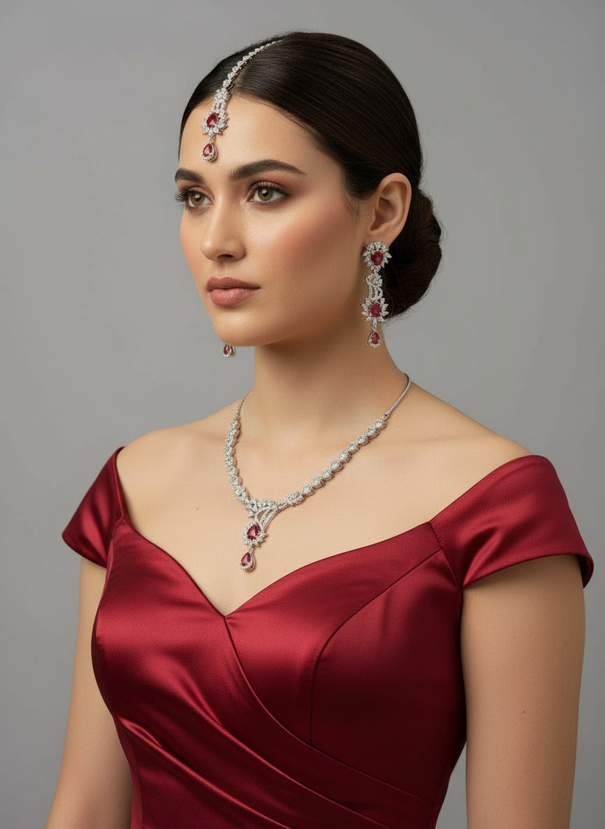 a rhodium-plated brass jewellery set with American diamond and semi-precious stones, including a necklace, earrings and maang tikka by famaza couture