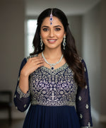 a rhodium-plated brass necklace,earrings and maang tikkawith semi-precious American diamonds and blue saffaire central stones by famaza coutre