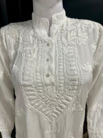 close up of Chikankari short kurti showcasing the intricate hand embroidery with floral motifs.