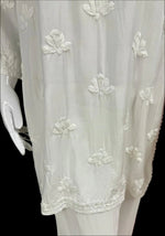 embroidery close up of the lower half of chikankari short kurti with floral motifs