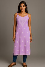 Model wearing Chikankari slip dress kurti in lavender colour with blue jeans and brown shoes