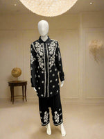 A traditional black with white floral embroidered cord set displayed on a mannequin, consisting of a front-open shirt and matching trousers.