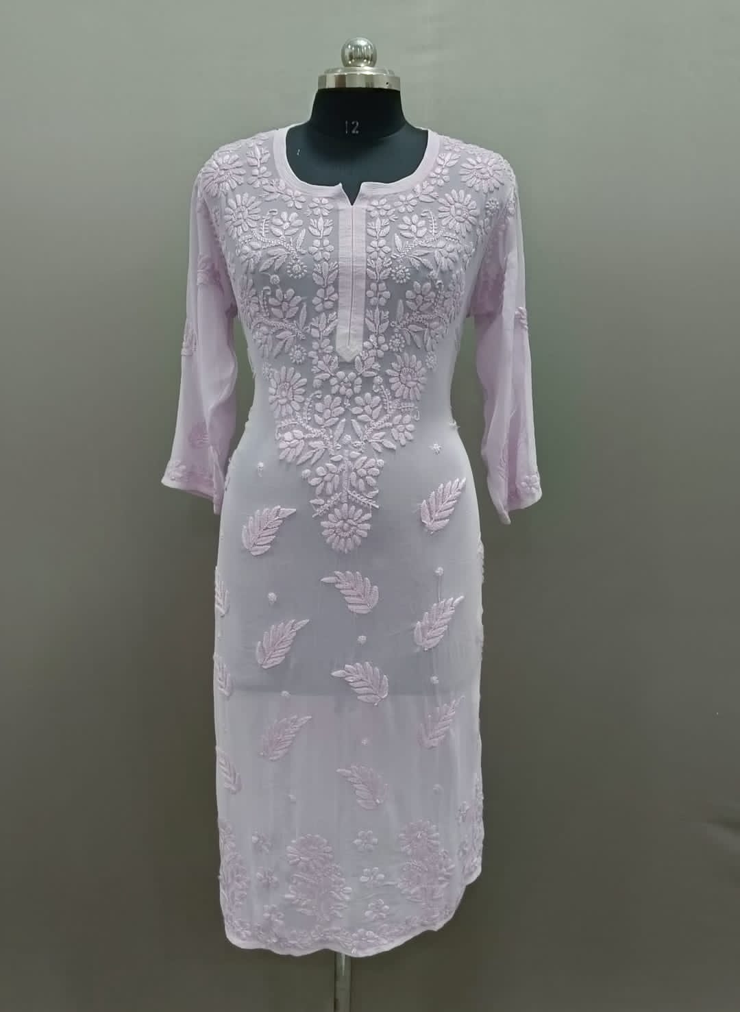 A long, pink viscose kurti with hand-embroidered Chikankari patterns displayed on a mannequin.