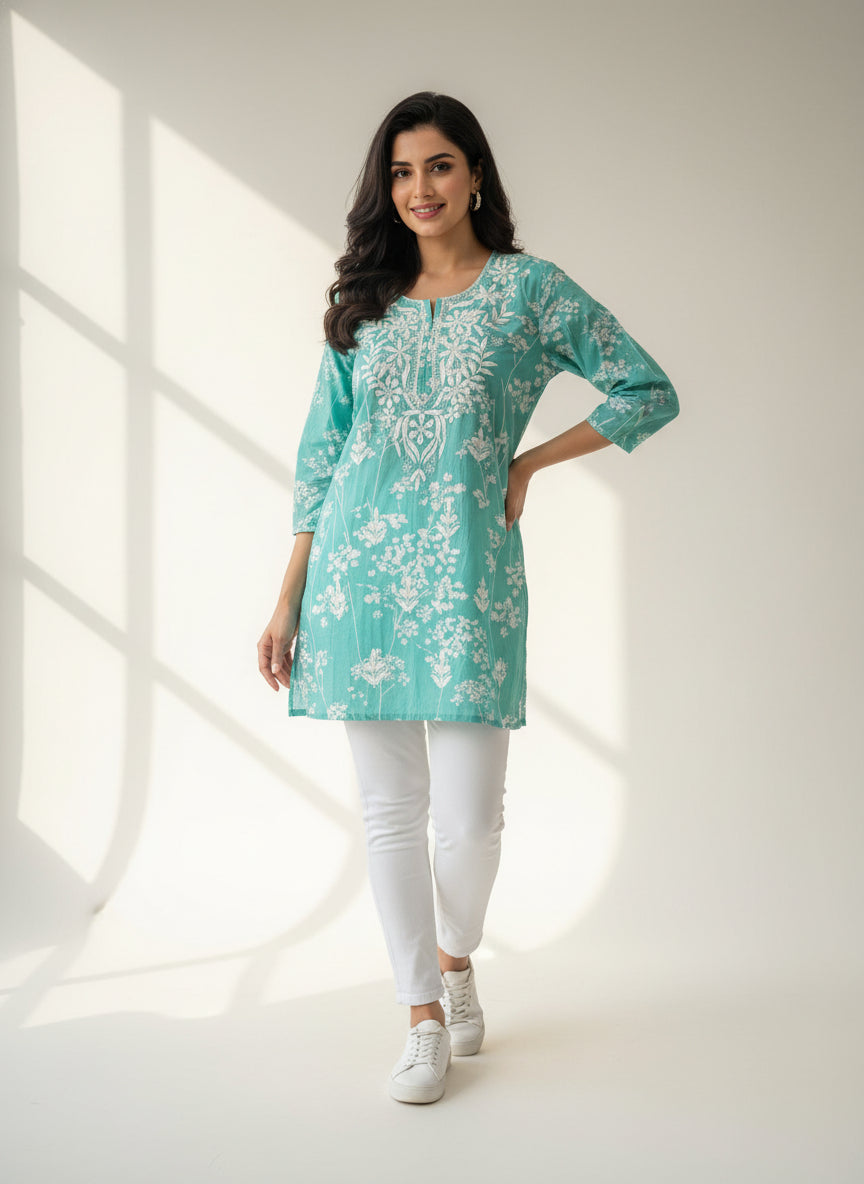 turquoise colour machine embroidered printed short length kurti with white jeans by famaza couture
