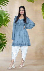 model wearing chikankari short kurti frock style with dhoti tulip trousers