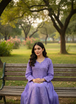 Mannequin wearing a purple dress