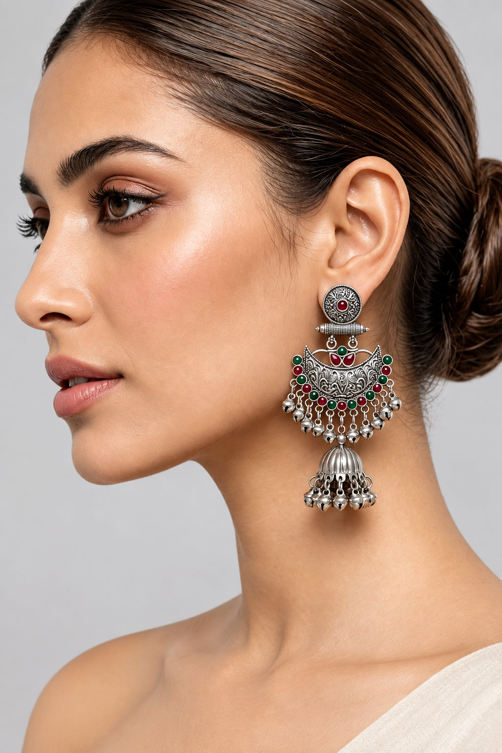 Model wearing Deepika oxidised silver-tone Chandbali jhumka earrings with red and green accents.