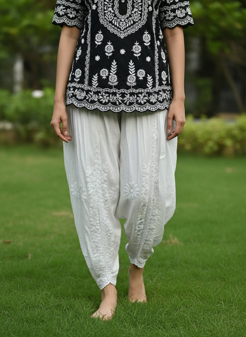 White Chikankari embroidery Dhoti Pants Tulip Trousers on mannequin