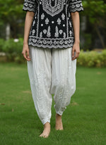White Chikankari embroidery Dhoti Pants Tulip Trousers on mannequin