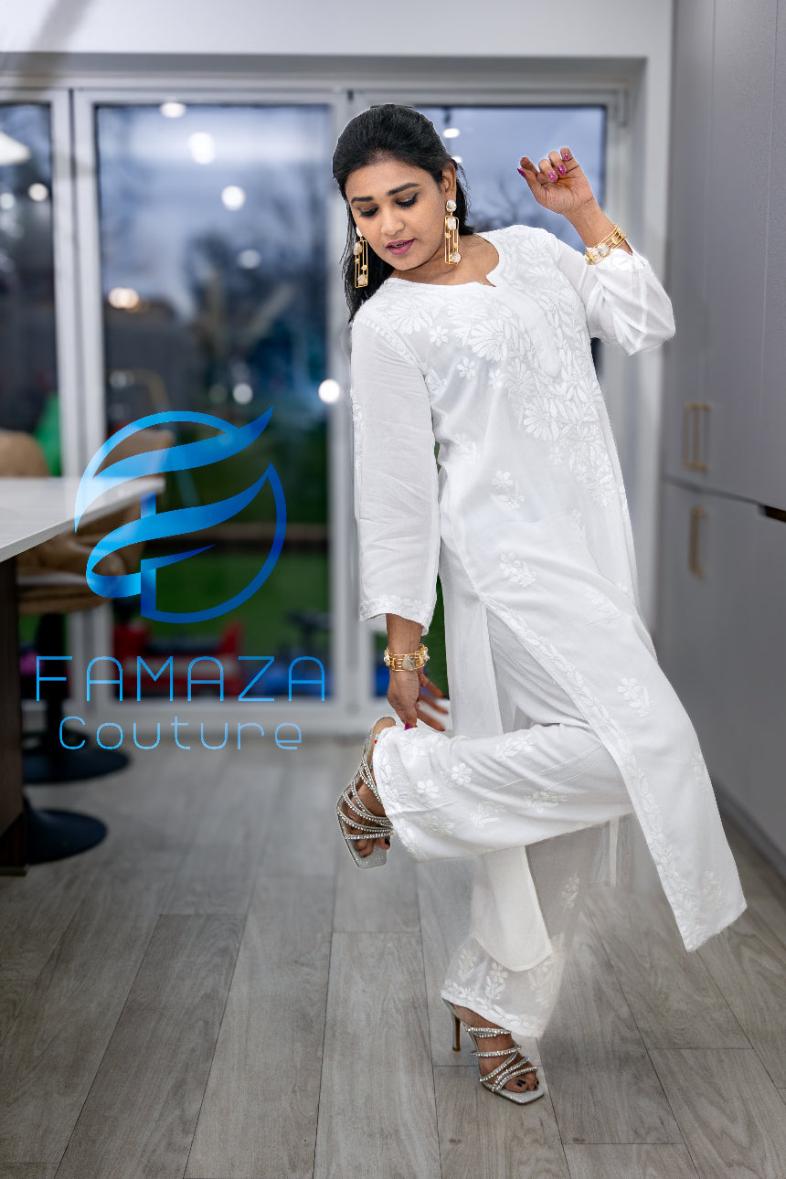 full side view of model wearing Floral chikankari kurti palazzo set in white with white embroidery