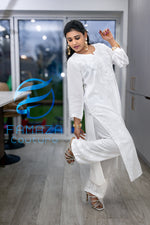full side view of model wearing Floral chikankari kurti palazzo set in white with white embroidery
