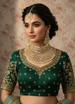 party wear A handcrafted golden choker set with matha patti displayed on a mannequin, featuring kundan and pearl embellishments.