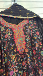 kanni silk kurti and dupatta is displayed on a hanger in a boutique.