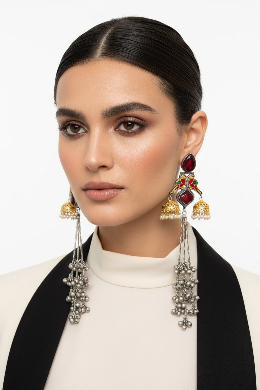 parrot figures golden and black long Kashmiri earrings with mini jhumkas on both sides and maroon stone in the centre.