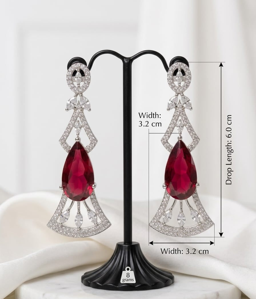 Aurora Jem crimson ruby statement drop earrings with clear cubic zirconia crystal accents in an Art Deco geometric silver-plated design, shown on a model