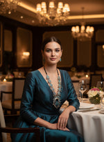 Decorative necklace with blue and silver design on a black stand.