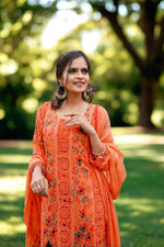 Model in vibrant orange floral embroidered Pakistani chiffon suit with dupatta – Famaza Couture