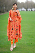 Model in vibrant orange floral embroidered Pakistani chiffon suit