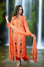 Model wearing orange floral embroidered Pakistani chiffon suit with dupatta and pants