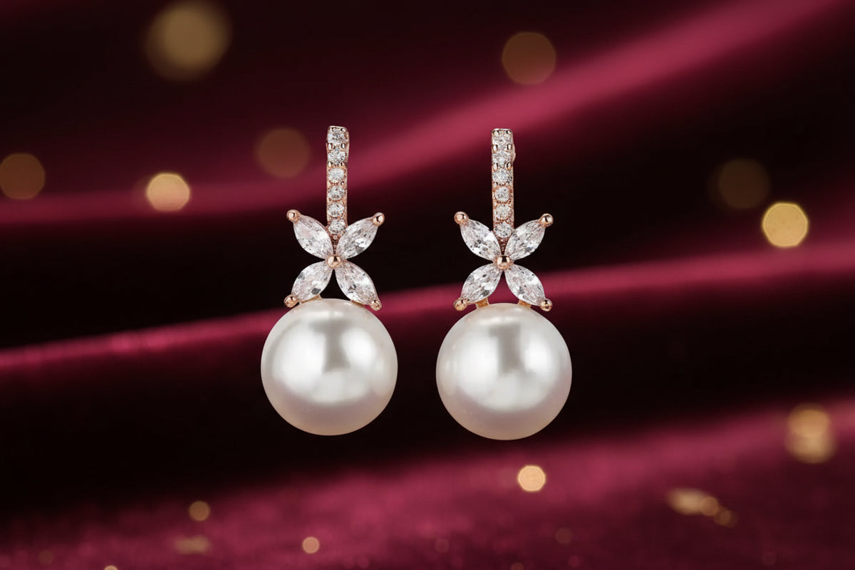 Pearl earrings with floral designs on a black background