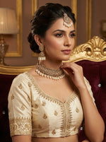 model is wearing Rose gold choker necklace and 2 jhumkas with maang tikka is displayed on the dummy.